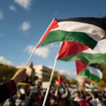 Palestinian Ballots Pushed To 2027 Palestinian flags waving at an outdoor rally