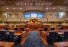 Mayor Denies Slur Claim as Probe Looms Courtroom interior with wooden benches and judge's bench