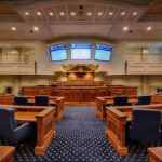 Mayor Denies Slur Claim as Probe Looms Courtroom interior with wooden benches and judge's bench