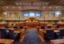Mayor Denies Slur Claim as Probe Looms Courtroom interior with wooden benches and judge's bench
