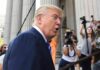 Press Room Meltdown After Trump’s Quiet Push man in suit speaking to media outside a courthouse