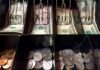 Cash register drawer with US bills and coins