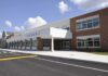 Modern school building with large windows and a clear sky