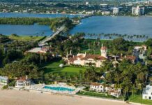 Trump’s Golf Deal Sparks County Showdown Aerial view of a waterfront estate with pool, lawns, and palm trees