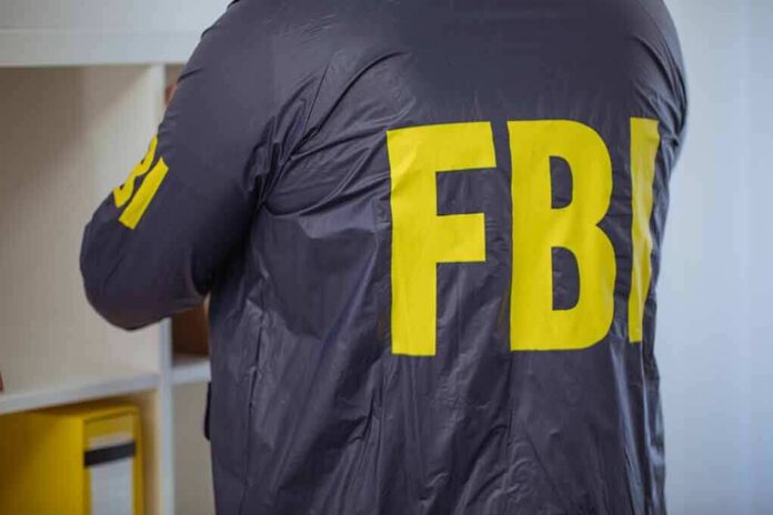 FBI agent in a dark jacket with large yellow letters