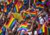 Hate Law Clash Erupts Over Rainbow Flyer Dontrelle Inman among crowd waving rainbow pride flags