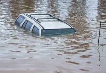 Live TV Heroics In Raging Flood A partially submerged vehicle in floodwaters