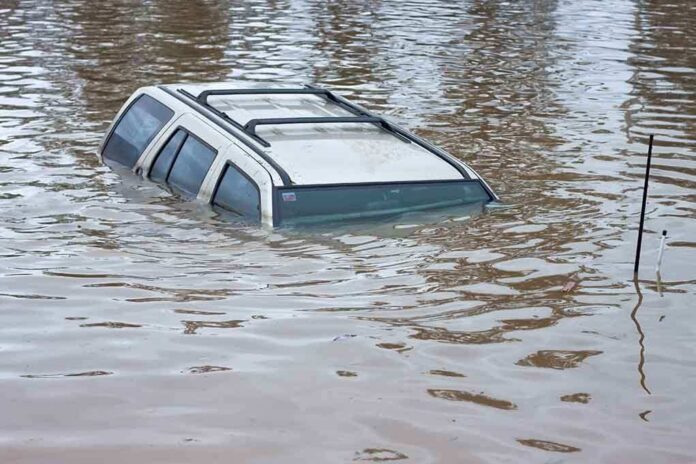 shutterstock_68552284 A partially submerged vehicle in floodwaters